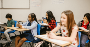 Kids using their phones in school.