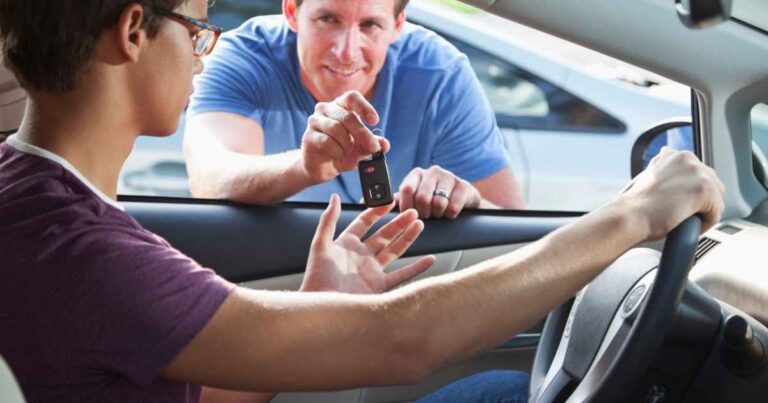 Father (40s) giving teenage son (15 years) car keys.