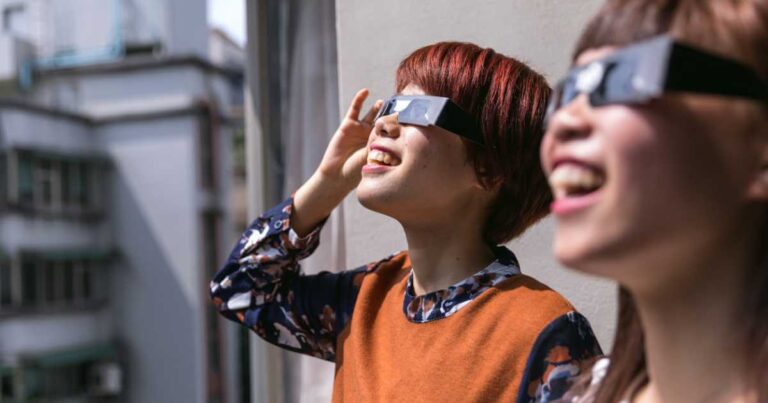 Young friends looking at the solar eclipse with eclipse viewers.