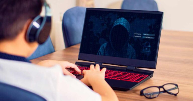 Teenage Boy In living room hacked by hacker on the table, stock image.