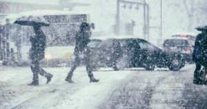 Pedestrians and traffic on a winter day.