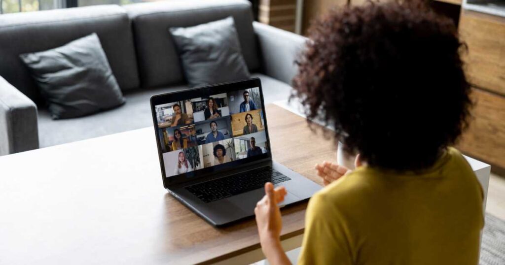 Woman talking to some colleagues in an online business meeting while working at home