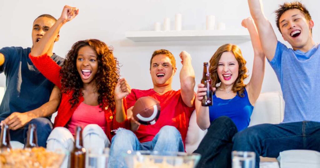 a group of friends watching football game