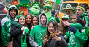 Participants and spectators at the annual St. Patrick's Day Parade that takes place on 5th Avenue in New York City. The parade is a celebration of Irish heritage in America and is the largest in the world.