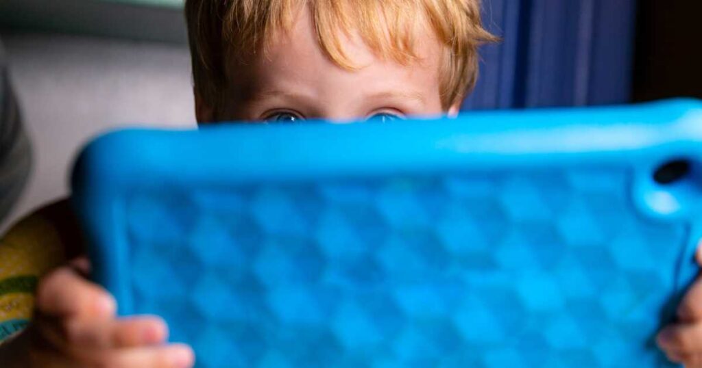 Caucasian Toddler Boy Plays With His Blue Tablet