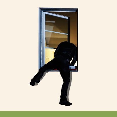 Burglar climbing a window breaking in a house