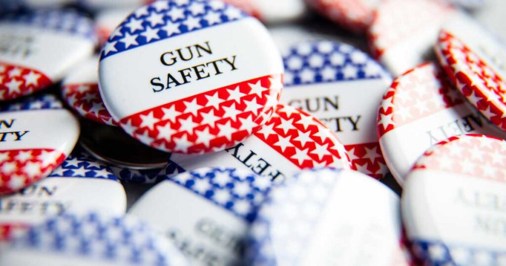 Close up of Gun Safety buttons, with red, white, blue and stars and stripes.
