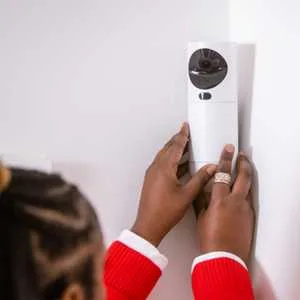 Someone installing the GuardVision Photo Detector camera from Verisure.