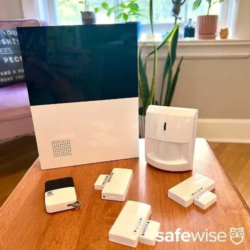 Abode Smart Security system hub, motion detector, sensors, and keyfob after unboxing.