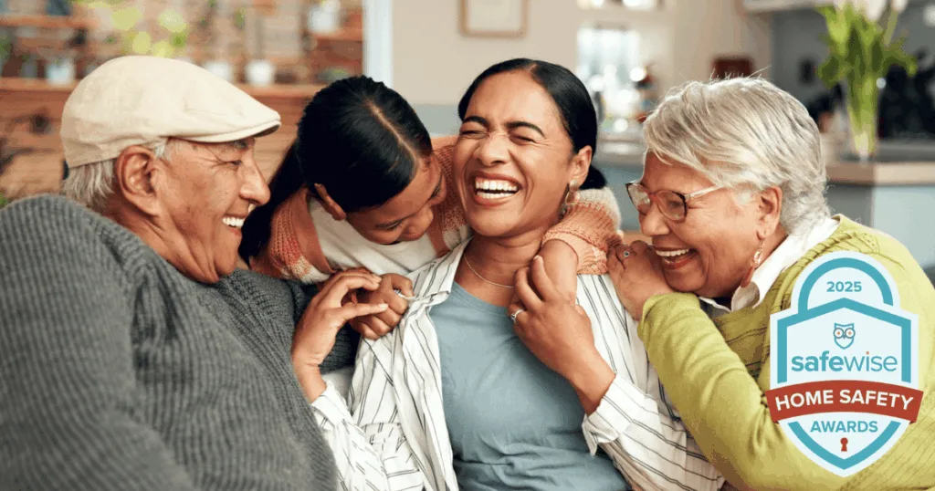 intergenerational family sitting at home together laughing