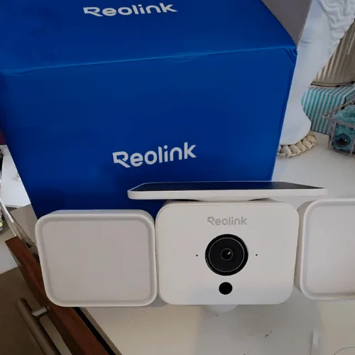 Reolink Solar Floodlight Cam next to its blue box.