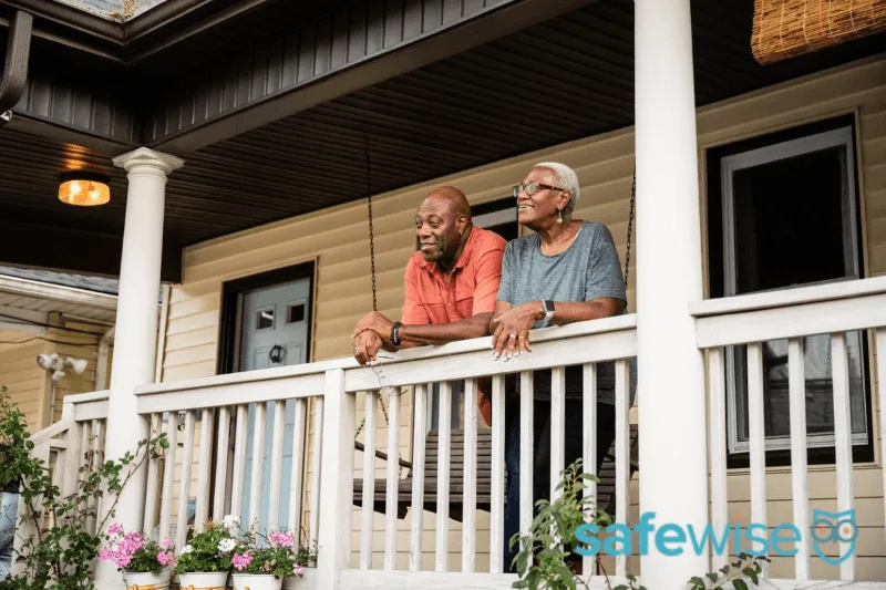 Two people leaning on a porch rail