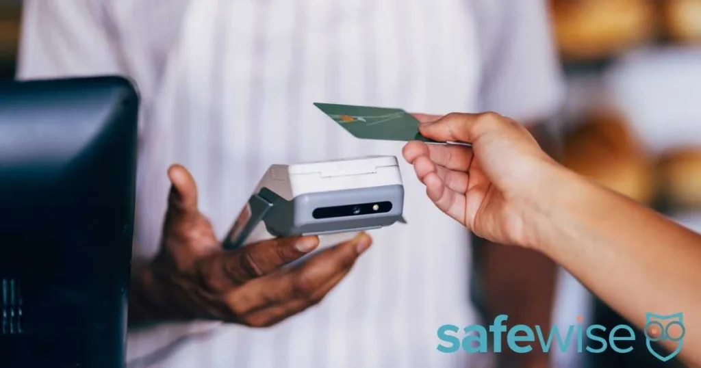 A customer uses a contactless card to make a payment at a retail store, showcasing tapping technology in shopping transactions.