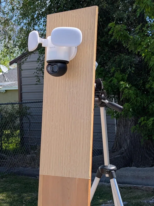 reolink trackflex floodlight wifi security camera outside on testing rig with tree and shed in background