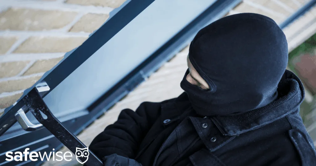 Burglar trying to pry open a door