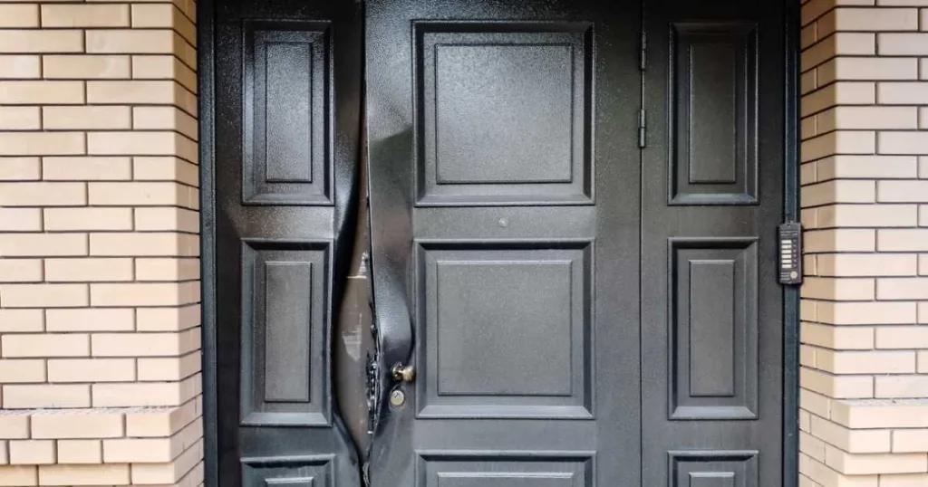 A broken lock on the door of a private brick house