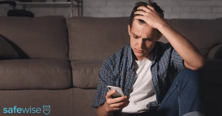 Teen upset while looking at his phone