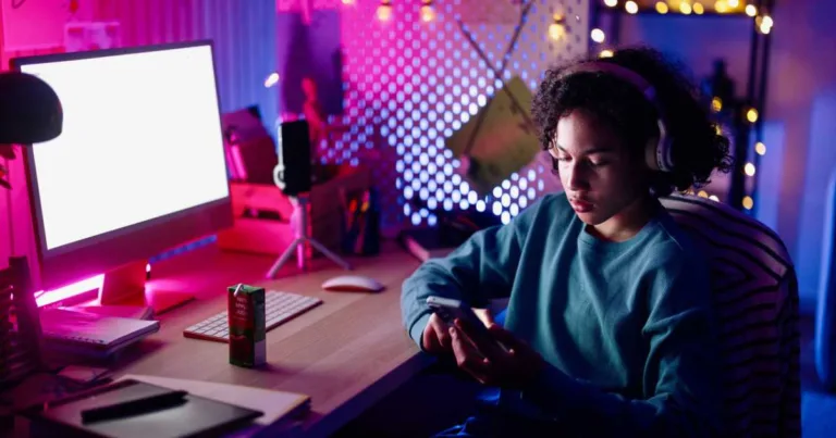 Relaxed teenager surfing the net at home at night