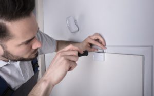 Installer setting up door sensor