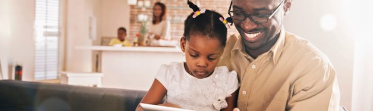 African American family, father and daughter looking at tablet