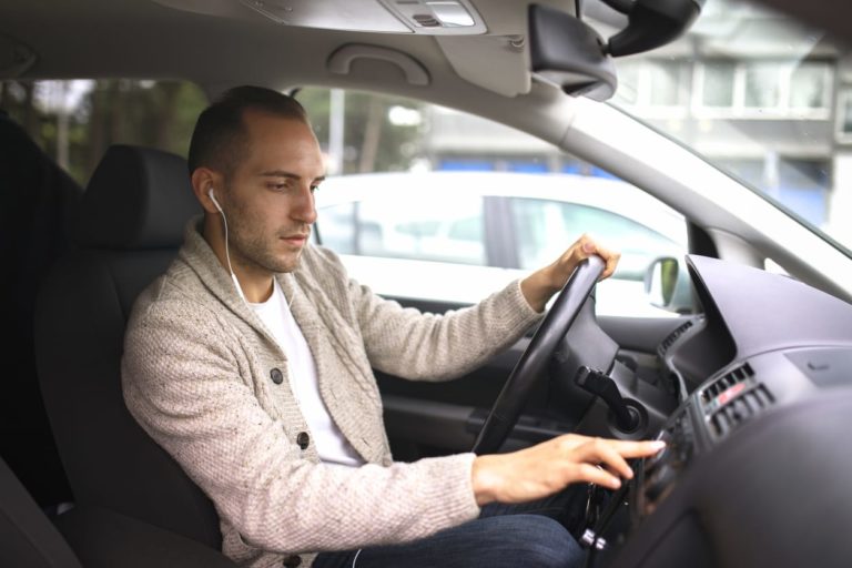 man driving with headphones