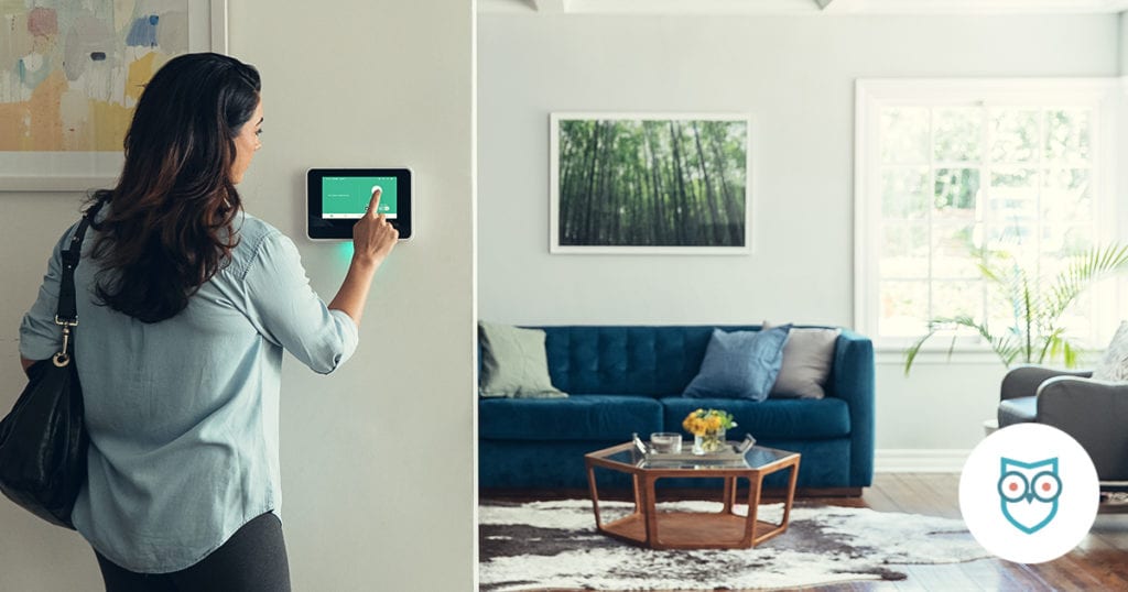 woman interacting with sky security panel in house