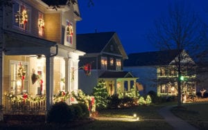 Row of houses decorated with lights for Christmas