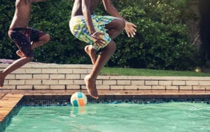 two kids jumping in pool