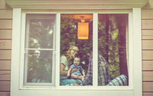 family with mom, dad, baby in window