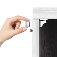 hand demonstrating how to install jambini cabinet lock