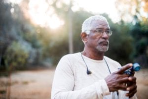 African American senior man using a smart device
