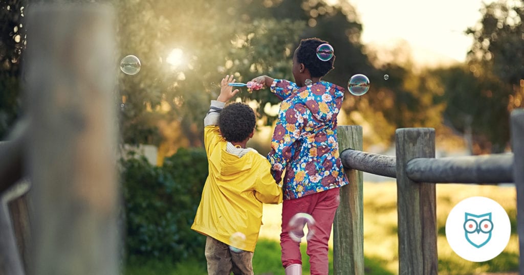kids at park blowing bubbles