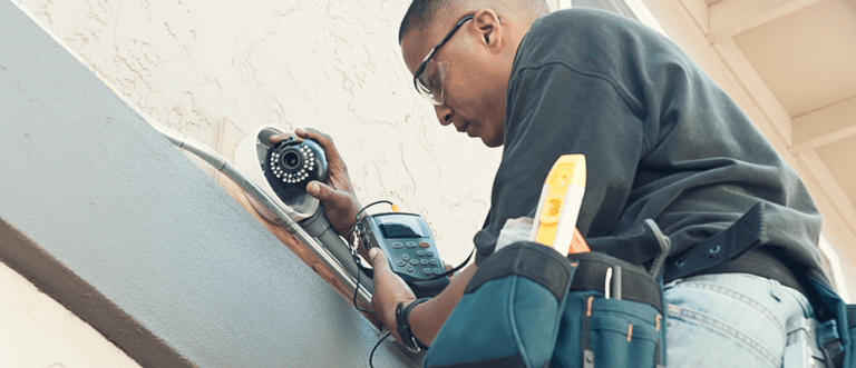 technician install a home security camera